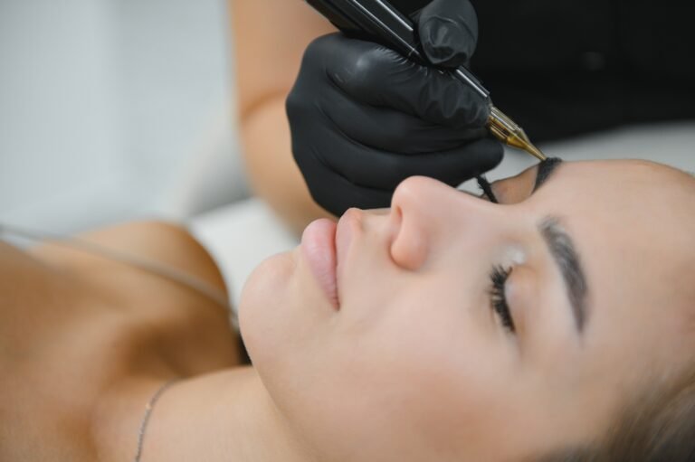 a cosmetologist applies permanent makeup to the eyebrows, eyebrow tattoo. eyebrow perm